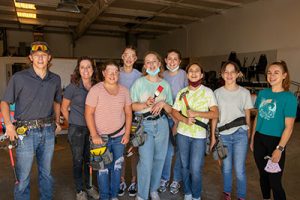 woman and students with tools